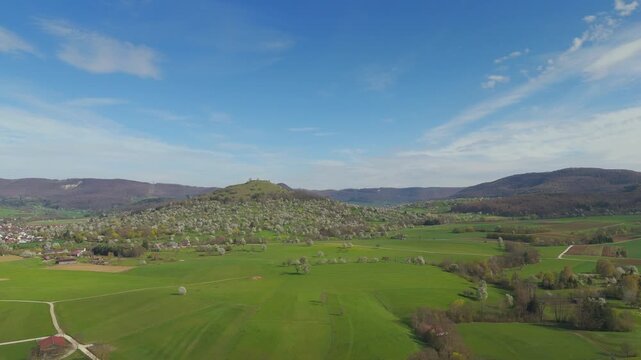 Aerial view of Limburg hill near Weilheim an der Teck in spring with blooming orchards and blue sky, Weilheim an der Teck