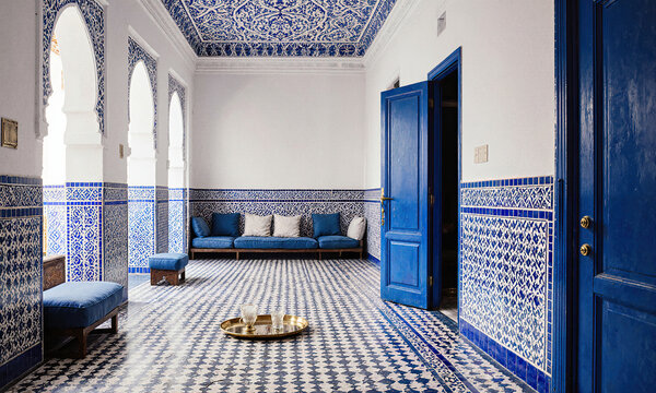Morocco medina room traditional Tangier interior features zellige tile floor brass tray and blue cushions