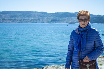 Fototapeta premium senior woman walking along the seafront