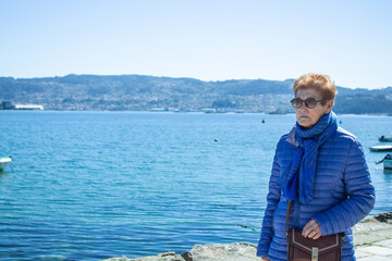 Fototapeta premium senior woman walking along the seafront