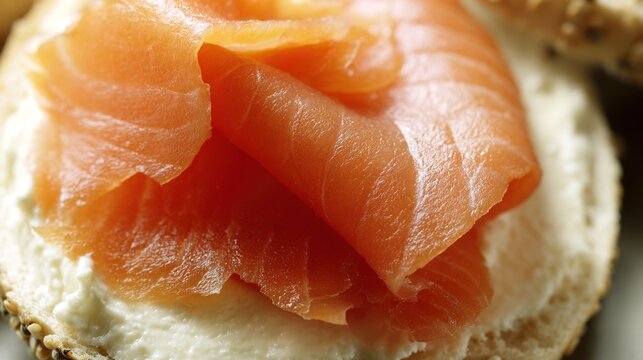 bagel. Single slice of orange-pink smoked salmon on cream cheese and bagel. menu design, packaging mockups, designed for food delivery and cloud-kitchen brand materials, used by curriculum designers.