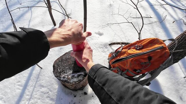 Outdoor Warmth Enjoyed. Hiker Sips Steaming Beverage Outside. Enjoying Hot Drink Beneath Clear Sky While Hiking In Nature. Hiker Relaxes Outdoors With Warm Beverage In Hand During Peaceful Day