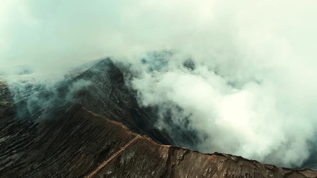 Drone overview of massive white plume rising from Mount Bromo crater, East Java, Indonesia