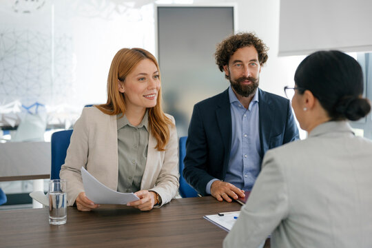 Businesswoman interviewed by experts in a modern office