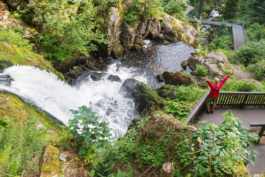 Woman cheering at Triberg Waterfall in Black Forest Germany