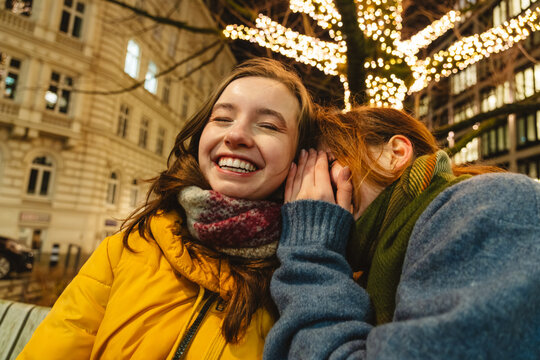Friends sharing laughter on a winter evening outdoors in Hamburg