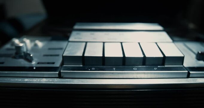 Opening the lid of a vintage tape recorder