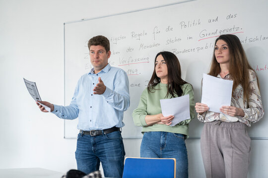 Students presenting in a multicultural classroom setting