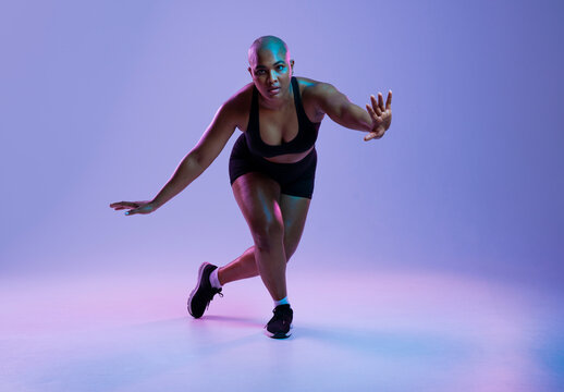 Athlete in sportswear exercising indoors with a dynamic pose