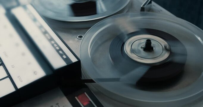 Close-up of a noir vintage tape recorder playing an old tape