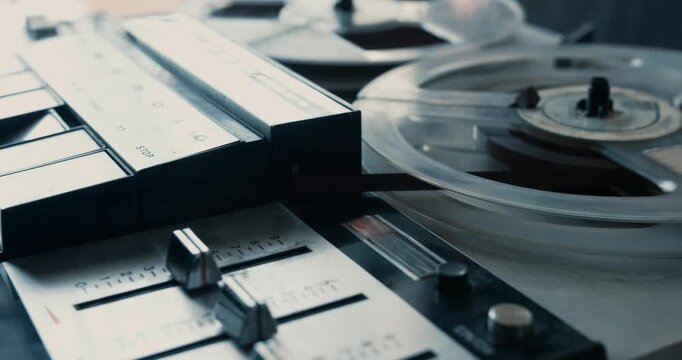 Close-up of a vintage tape recorder playing an old tape