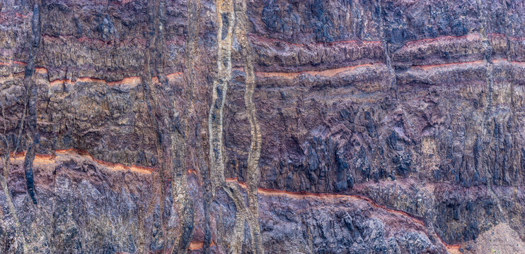 Steep cliff on the volcanic peninsula of Ponta de S&atilde;o Louren&ccedil;o at the east-coast of the isle of Madeira; close-up of layers of lava and volcanic ash, Madeira Portugal