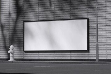 Fototapeta premium White horizontal street billboard on concrete wall and roadside for mockup template