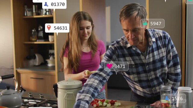 Daughter and father making food at counter peeling banana sparking social icons showing engagement