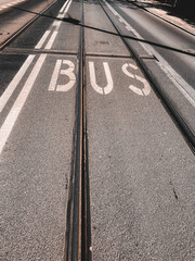 Fototapeta premium Tram tracks and bus lane marking on asphalt road, urban public transport infrastructure detail in city street
