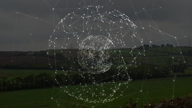 Rotating digital wireframe globe showing pulsing inner core over rural green fields and hedgerows