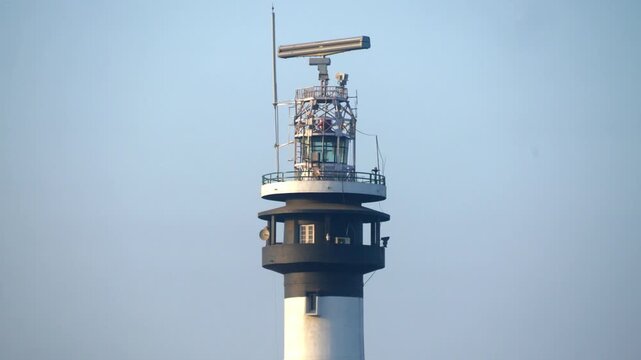 Indian Lighthouse in Moti Daman, a historic active lighthouse with a tall tower near the sea coast, captured in daytime with clear sky