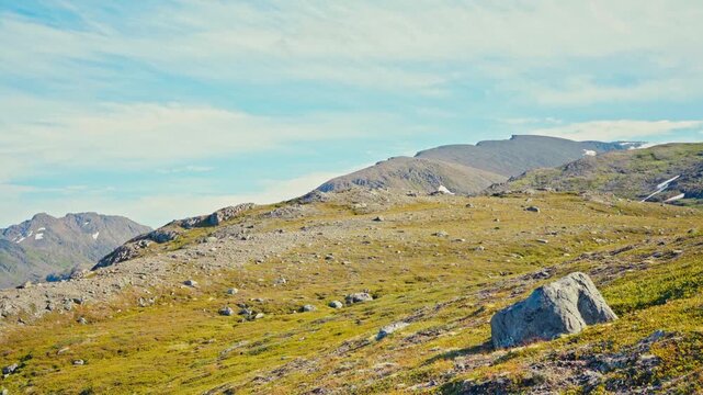 Middagsfjellet, Sandland, Nordkapp, Finnmark, Norway - The Rocky Hillside Stretches Toward the Mountains Under a Wide Blue Sky - Wide Shot