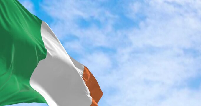 Ireland national flag waving in the wind on a clear day. Vertical tricolour of green, white, and orange. European Union state member. Seamless 3d render animation. Slow motion loop. Selective focus