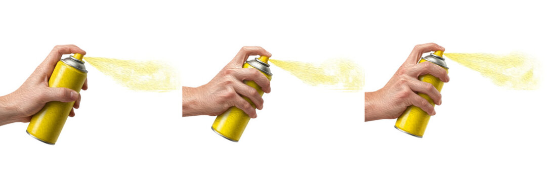 Hand holding yellow spray paint can releasing pigment mist isolated on white background, aerosol container for graffiti art, DIY home projects and creative crafts, professional tool set.