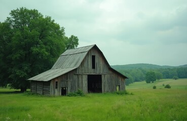 Obraz premium Old wooden barn sits in a rich green field with rolling hills in background. Tall trees border the grassy meadow. Overcast sky hovers above the rustic countryside structure.