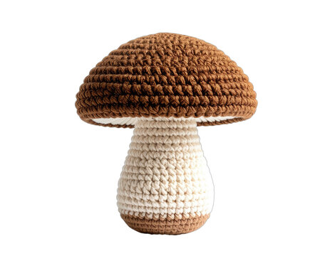 A charming crocheted mushroom sits against a stark black background, showcasing intricate detail and a cozy, handmade aesthetic.