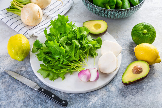 Fresh green vegetable with spinach and lettuce with avocado and lemons