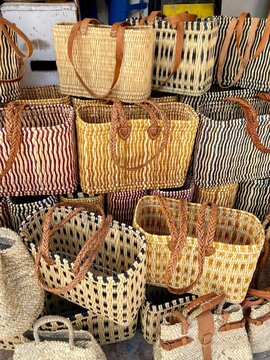 Colorful straw bags sold in street market in  in Marrakech, Morocco .