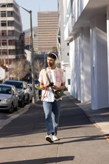 Man walking city sidewalk tapping smartphone and activating animated technology HUD for navigation © wavebreak3