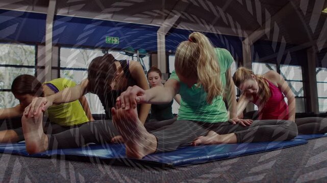 Session starting, group of five bending forward, reaching feet, improving flexibility on blue mat
