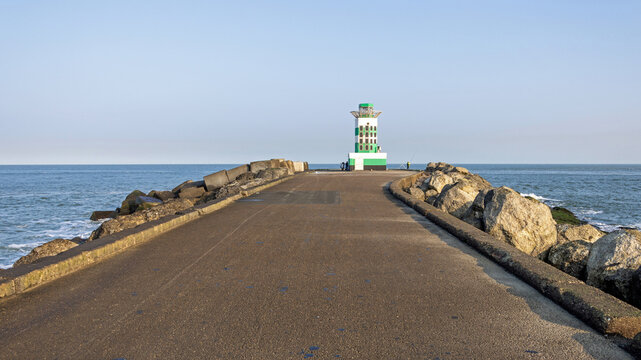 End of IJmuiden pier and lighthouse in the North Sea (Netherlands) on a sunny and tranquil winter morning