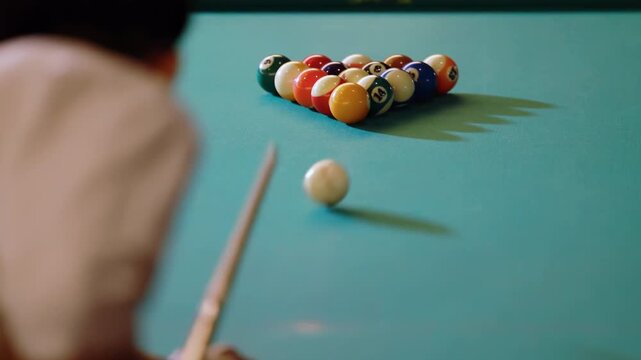Experience billiard player smooth precise play with cue aiming at colorful balls opening spread on billiards pool green table, man breaks first shot snooker balls by hitting white ball, starts game