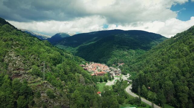 Setcases mountain village surrounded by forested Pyrenees valley