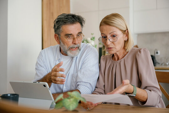 Couple discussing bills and financial problems at home