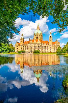 New Town Hall Hannover reflected in lake under blue sky summer day