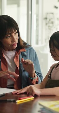 Mother, child and talk in home with homework, math assessment and problem solving for skill development. Woman, daughter and conversation in house with numeracy task, help and learning for education.