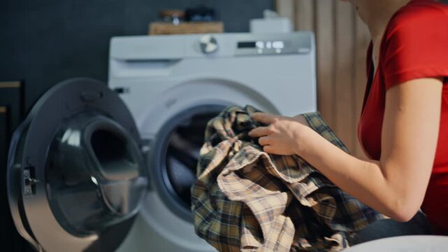 Closeup woman busy housework home. Unrecognizable brunette putting dirty clothes