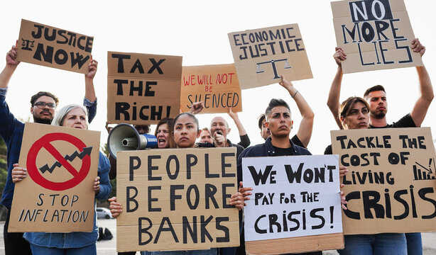 Crowd of multiracial people protest against inflation and financial crisis - Protesters marching for rise cost of living and fuel - Main focus on asian woman face