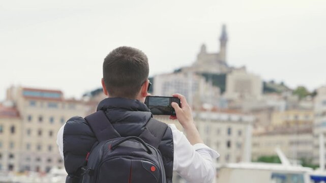 Tourist Captures Iconic Notre Dame de la Garde with Phone in Marseille