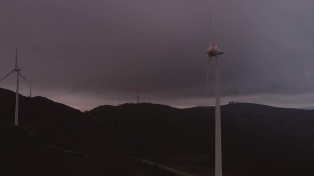 Wind turbine on Serra da Boneca in Penafiel Porto District Norte Portugal with visible nacelle and rotor detail under stormy sky in Iberian Peninsula European Union setting, drone close orbit slow