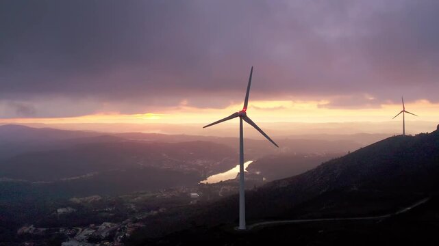 Wind turbine on Serra da Boneca in Penafiel Porto District Norte Portugal overlooking Douro Valley river under sunset sky in Iberian Peninsula European Union setting, drone slow orbit reveal
