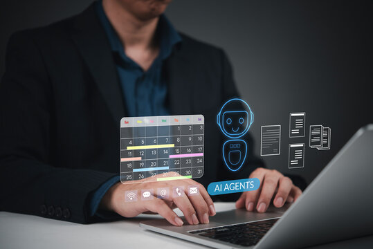 Businessman using laptop with AI agents virtual assistant hologram. Concept of artificial intelligence workflow automation, schedule calendar planning, task management and business productivity.