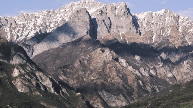 running couds in timelapse as a sign of running time over a mountain on Lake como