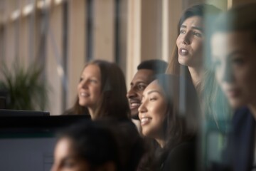 Obraz premium Coworkers looking through window showing teamwork communication and modern workplace environment