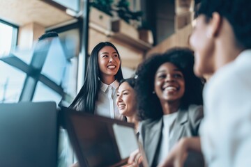 Obraz premium Diverse coworkers smiling together showing teamwork collaboration and positive modern workplace environment indoors