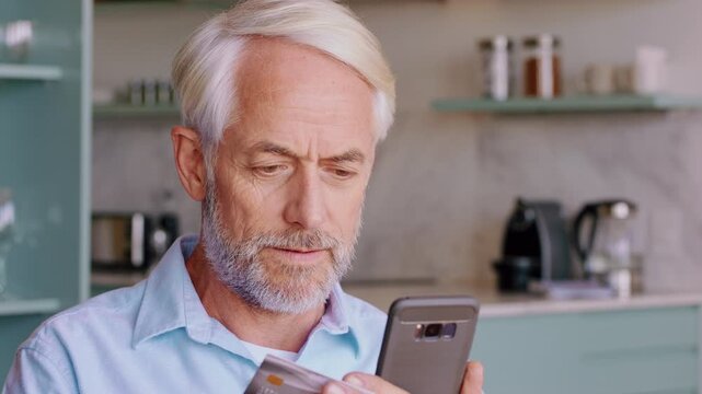 Man, typing and credit card in home with phone, search website and purchase for online shopping sale. Mature person, tech and scroll in apartment with digital banking, ecommerce payment and discount.