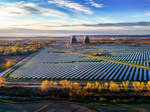 Trino, Italy - 30 March 2026: Aerial view of the expansive solar farm, its panels gleaming under the sky, juxtaposed against the massive cooling towers.