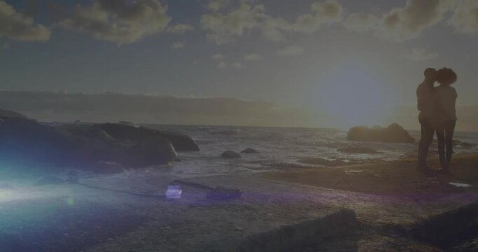 Animation of light spots over african american couple embracing