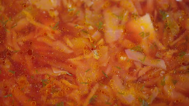 Rustic dish with tender vegetables. Steaming bowl of flavorful borscht stew. Closeup view of simmering red borscht filled with fresh shredded beets potatoes and carrots