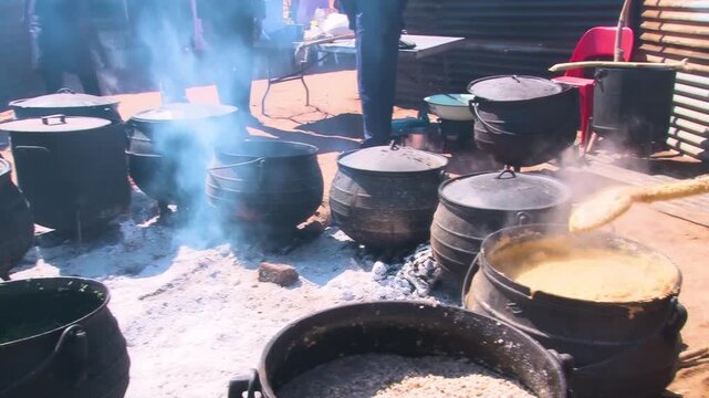Traditional Setswana Cooking of Samp and Pap in Cast Iron , Potjie Pots